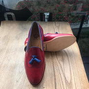 Red loafers with blue tassels