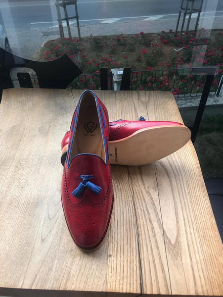 Red loafers with blue tassels