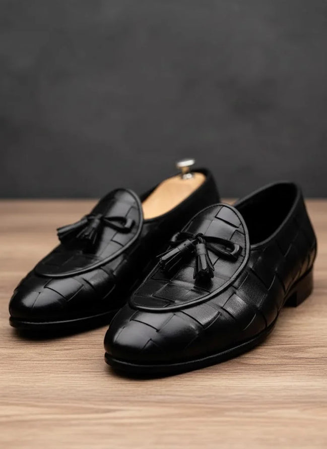Black loafers with tassels
