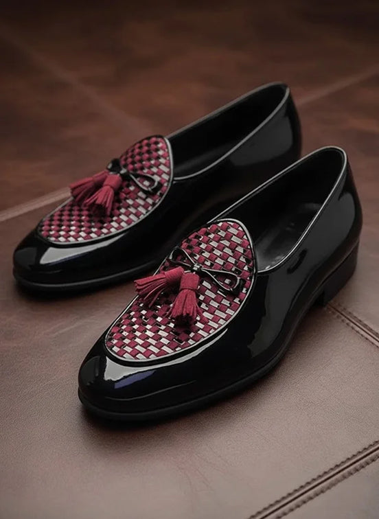 Black loafers with red and white checkered tassels