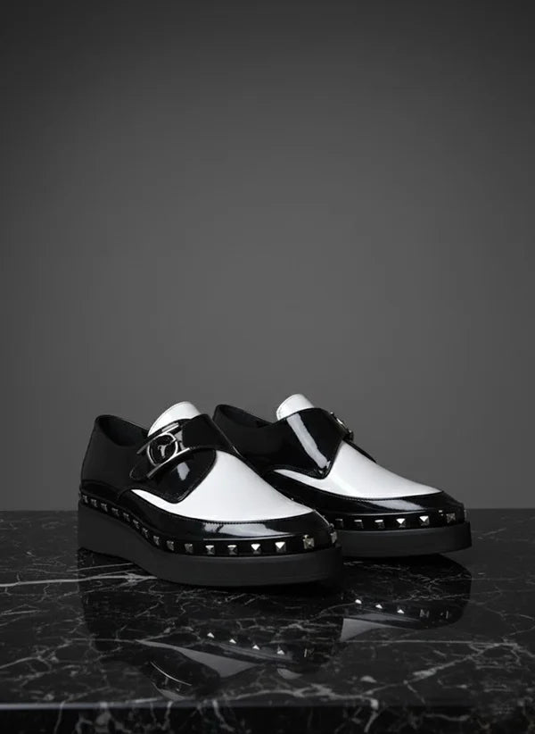 Black and white shoes with studded details
