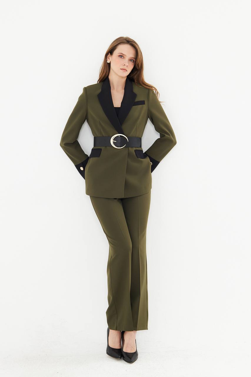 Woman wearing a green suit with a black belt