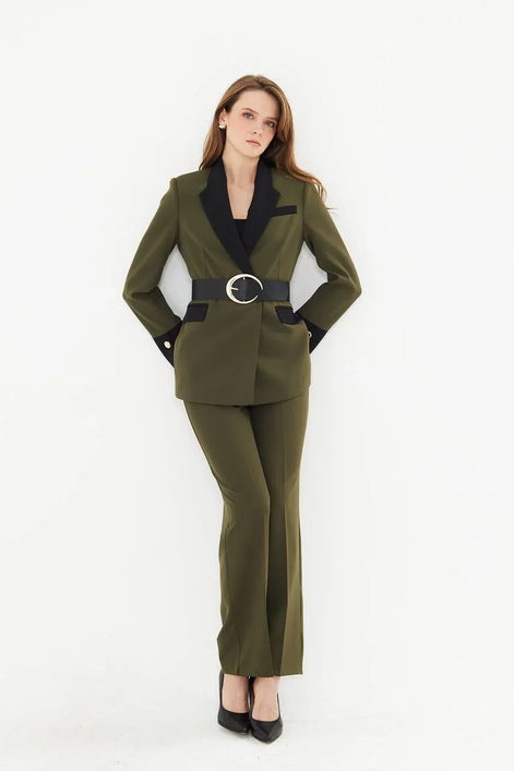 Woman wearing a green suit with a black belt