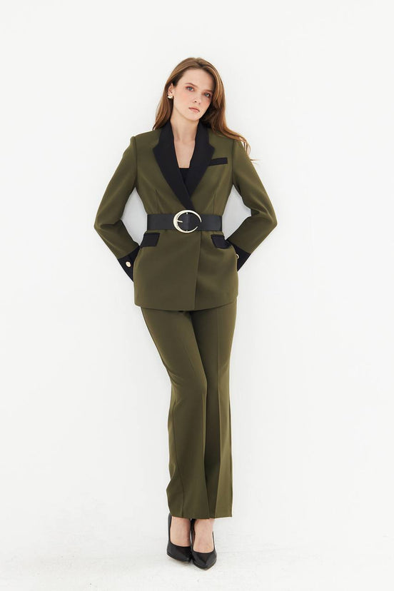 Woman wearing a green suit with a black belt