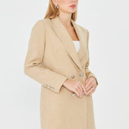 Woman wearing a beige coat on a white background