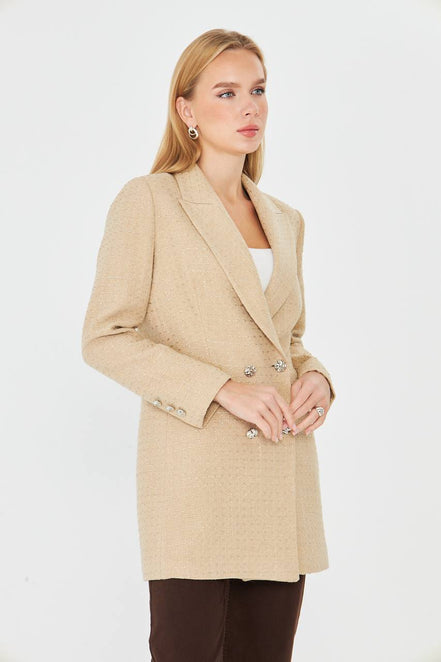 Woman wearing a beige coat on a white background
