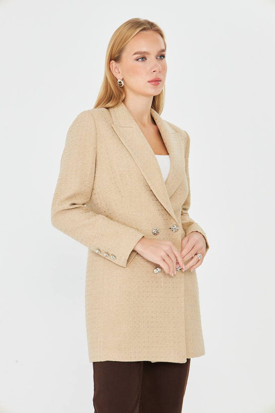 Woman wearing a beige coat on a white background