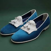 Blue loafers with white tassels