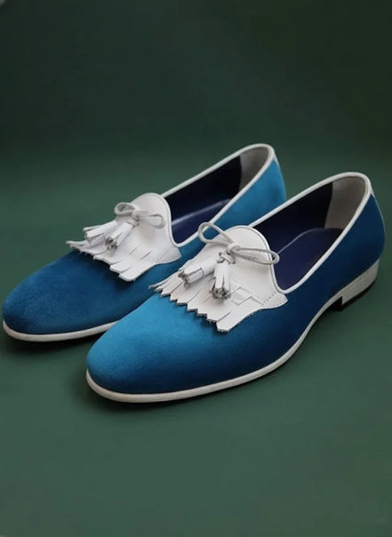 Blue loafers with white tassels
