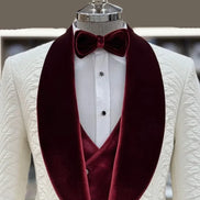 White suit jacket with burgundy velvet lapels and a matching bow tie