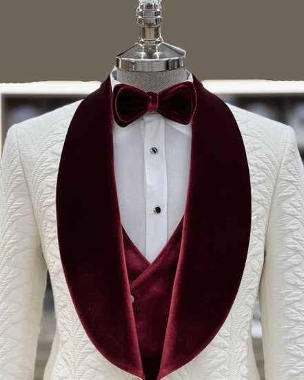 White suit jacket with burgundy velvet lapels and a matching bow tie