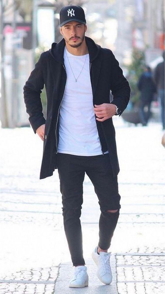 Premium Photo | Young brunette man in black pants, jacket and white t-shirt  smiles outside